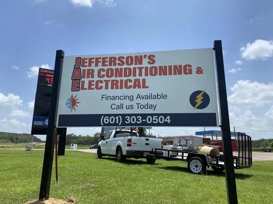 Jefferson's AC & Electrical roadside sign with work truck in Tylertown, MS
